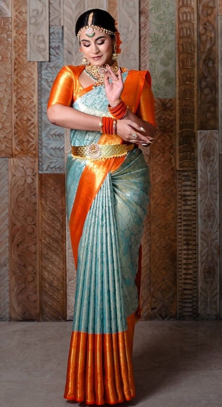 Model in a full silk saree with neat pleats